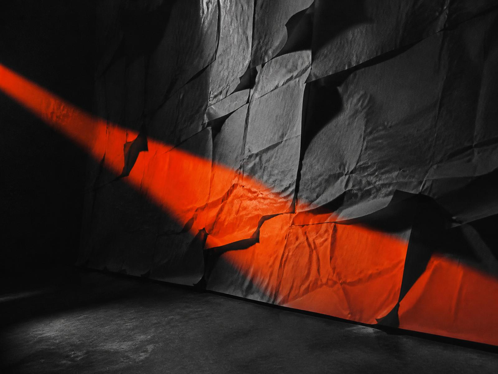 Creative studio poster wall lit by a single beam of light